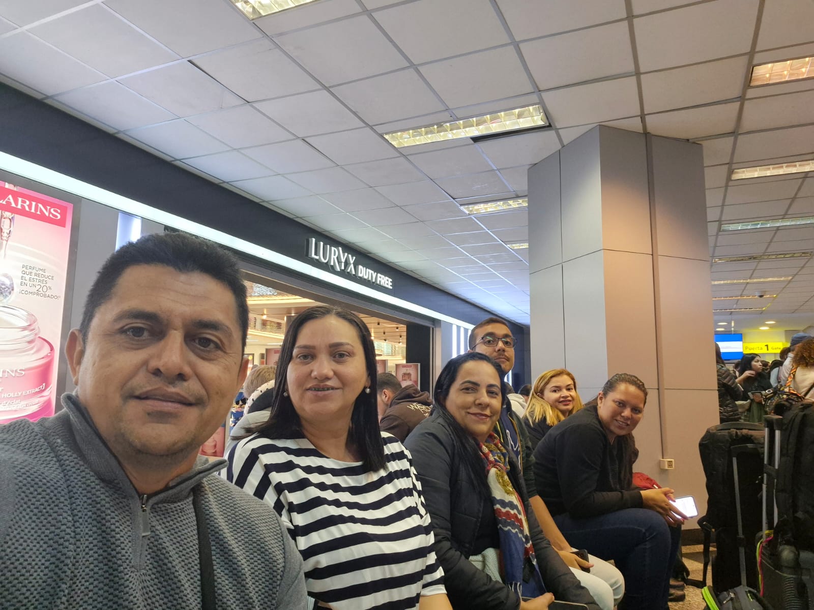 Grupo de alunos aguardando no saguão do aeroporto